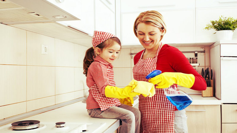 a woman with her daughter inside a kitchen