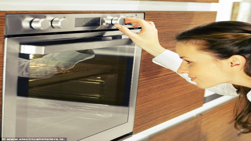 a young woman checking an oven