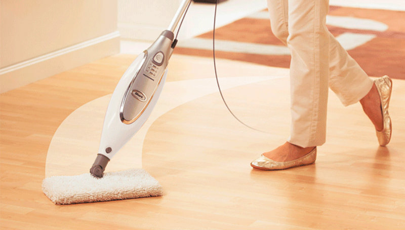 cropped image of a woman moping the floor