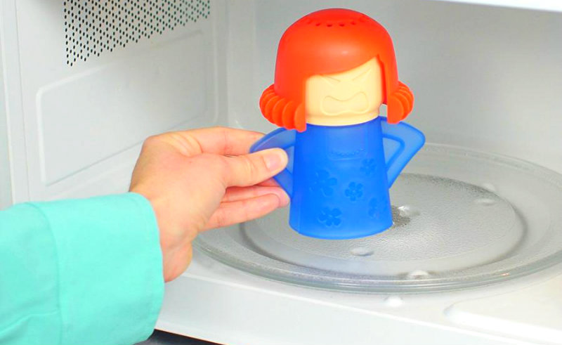 cropped image of a woman putting angry mama tool inside a microwave