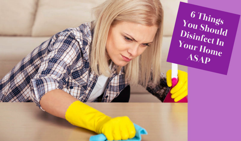 beautiful young woman wiping table with rag