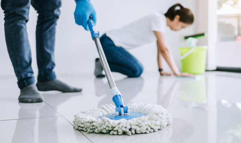 A couple is moping the floor