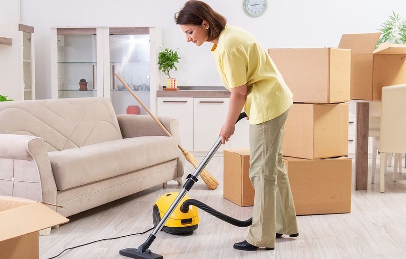 young woman vacuuming her living space