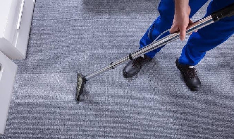 young professional wiping a carpet