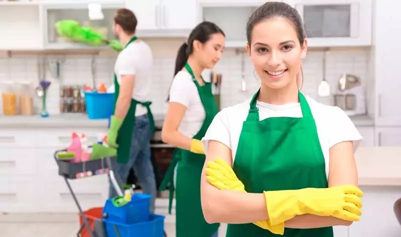 group of professional with green apron making a kitchen tidy