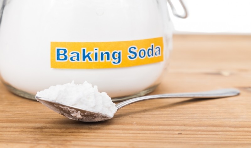 a bowl and a spoon full of baking soda