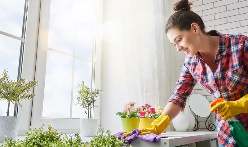 young woman wiping a surface with a cloth