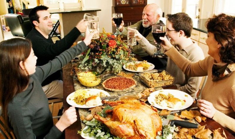 entire family enjoying thanksgiving dinner party
