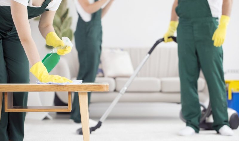 group of professional cleaners sprucing up a property