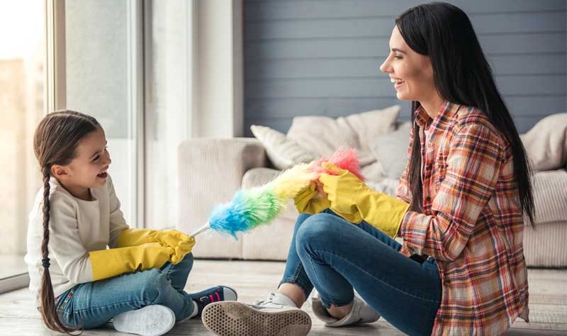 Happy mother sitting on the floor with her daughter
