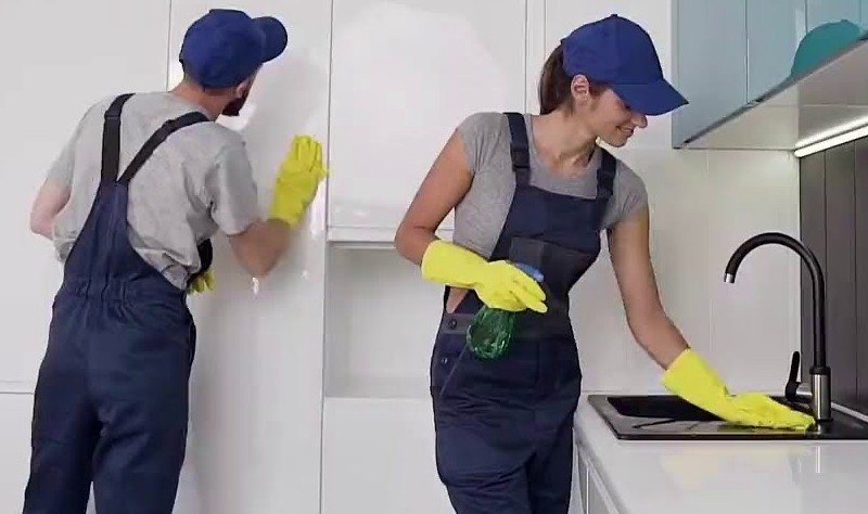 professional cleaners sprucing up a kitchen