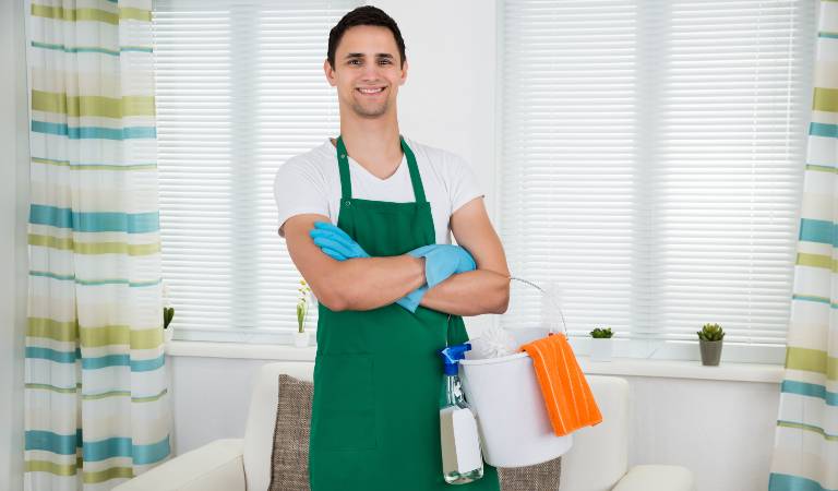 Man in white-green dress holding a white basket