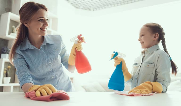 Happy woman holding a orange bottle in her hand and a young kid holding a blue bottle in her hand.
