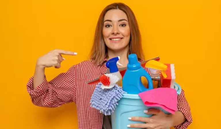 young woman with a bucket full of cleaning supplies