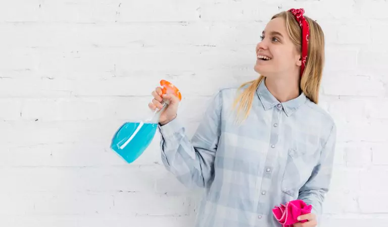 woman with a cleaning spray ready for a cleanup