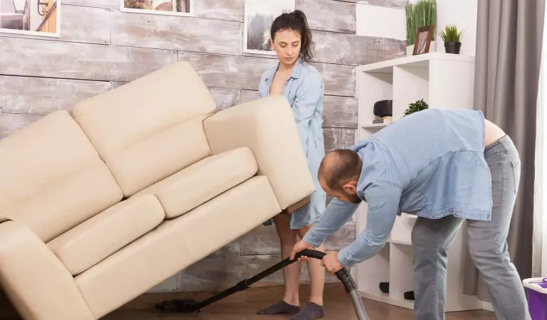 couple cleaning their house during the end of lease