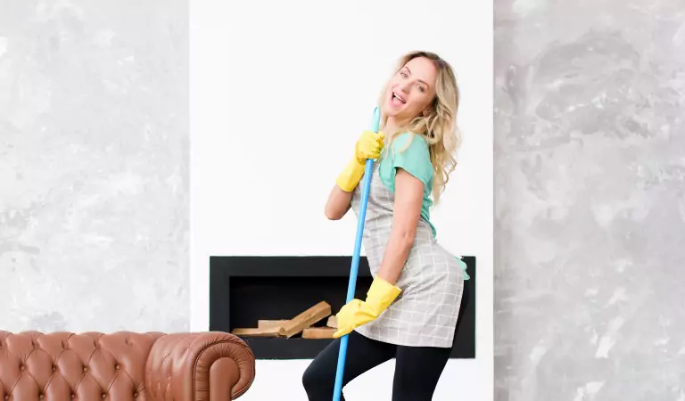 woman enjoying while sprucing up her house