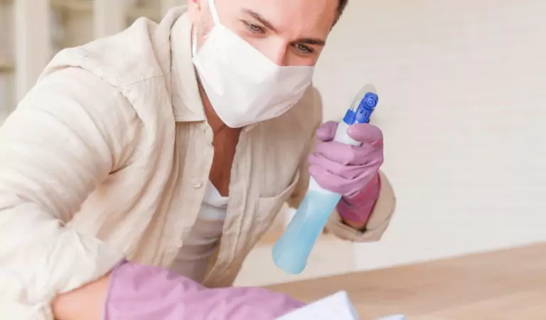 person cleaning a surface inside of a house