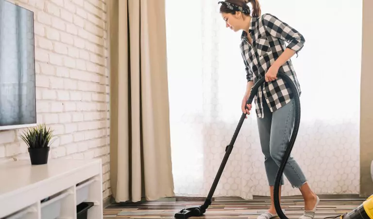 woman cleaning the flooring surface of a house