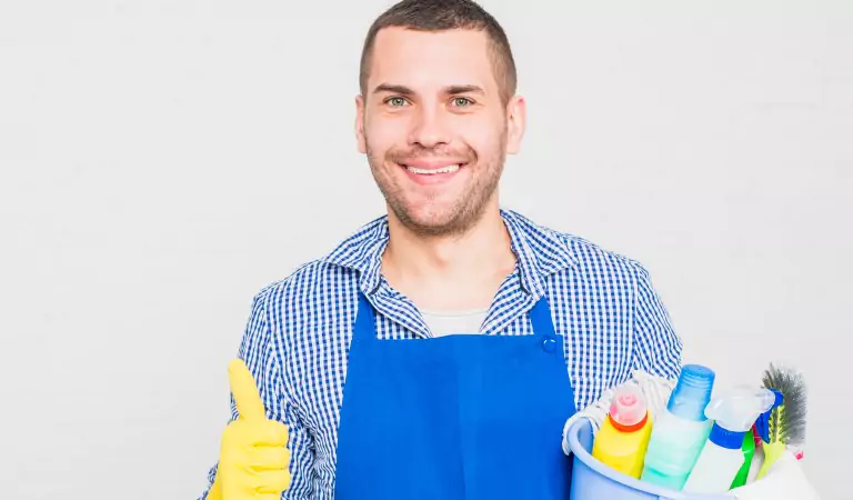 young man with some cleaning supplies ready to clean