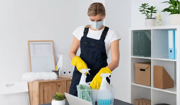 Lady in yellow gloves planning to clean office space.