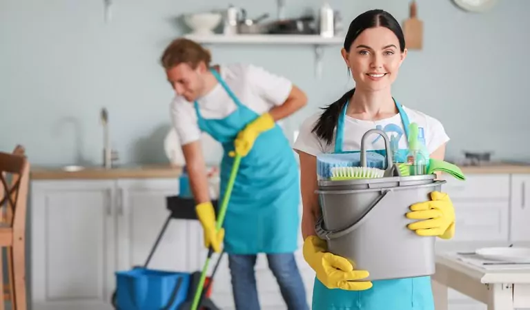 professional cleaners with some cleaning supplies during a house cleaning