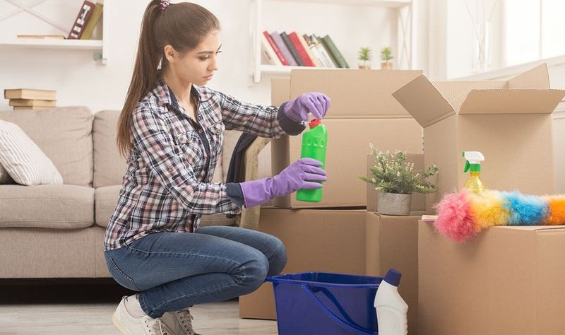 A beautiful girl is cleaning her house
