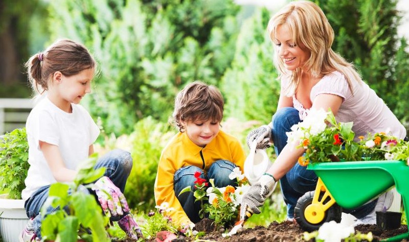 A mother is with her kids in a gerden