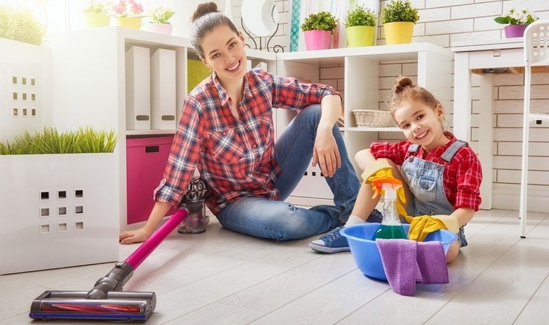 a woman is sitting on floor with her daughter