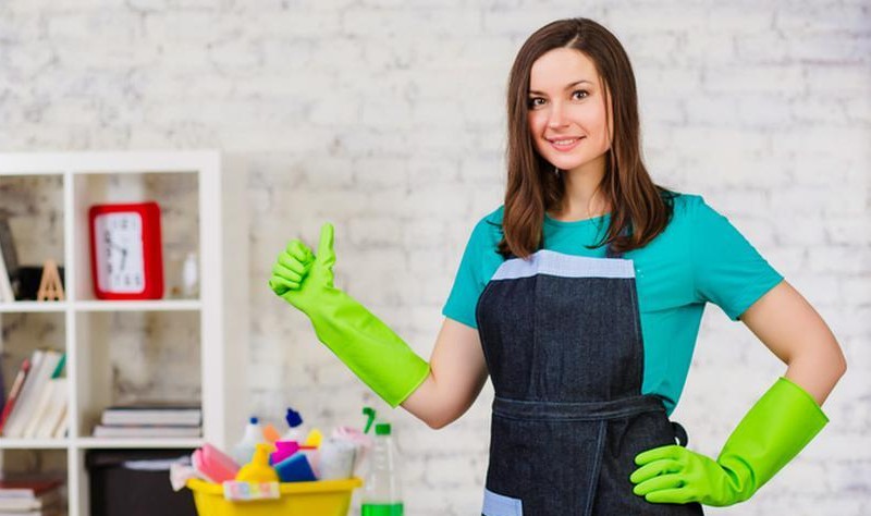 beautiful young woman with green gloves showing thumbs up