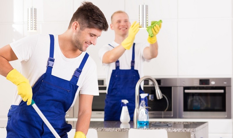 young professionals sprucing up a kitchen