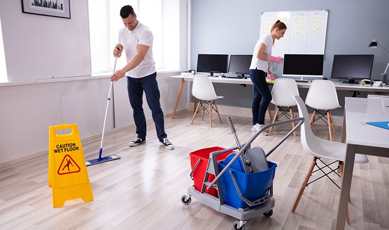 Professional couple sprucing up an office property