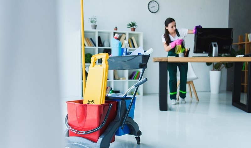 Young professional sprucing up a workspace