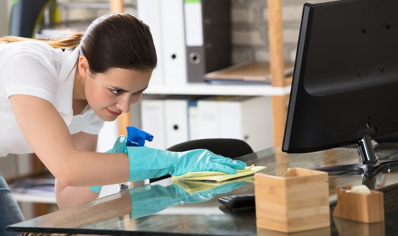 young woman sprucing up an office
