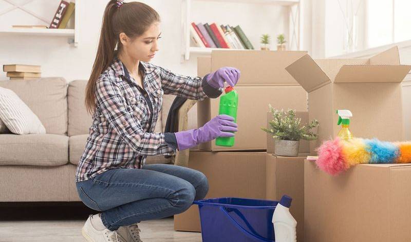 Woman in check shirt opening green bottle in hand