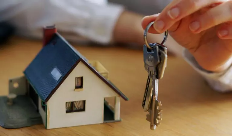 cropped picture of a key and a dummy house