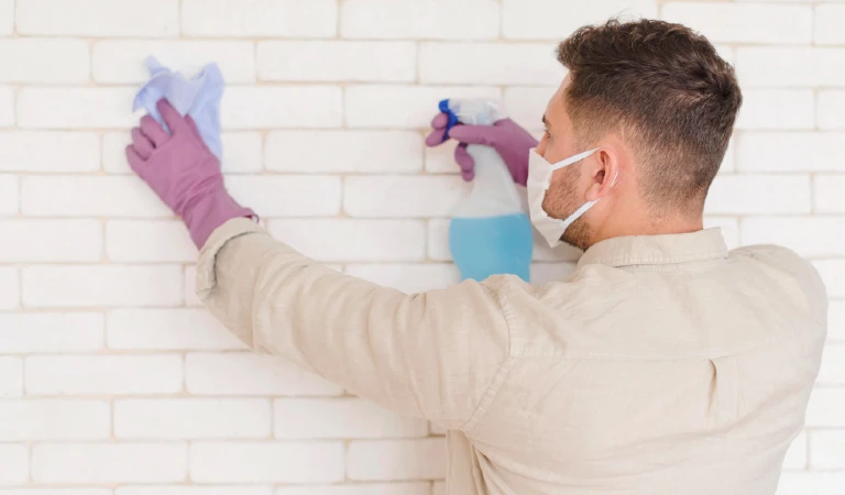 man cleaning the wall
